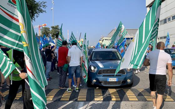 Italian workers on strike at Naval Support Activity Naples crowd the road leading to the base's main gate on June 30, 2023. Two unions representing 4,000 Italian workers at U.S. military bases across Italy called for a strike to protest stalled contract negotiations. 