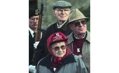 Michael Abrams/Stars and Stripes
Olizy, France, November, 2000: American World War II veterans John Lindsey, Blanche Scherbarth and Art Scherbarth take part in a memorial dedication ceremony for 1st Lt. Richard Noble, who was executed after being captured by the Nazis in 1944. Jonn Lindsey and Blanche Scherbarth served with the 109th Evacuation Hospital, and followed the front from Normandy to Pilzen. The Scherbarths met in France, and were married soon after. Behind the trio is Airman 1st Class Joshua Jameson of the USAFE Elite Guard, out of Ramstein Air Base, Germany.