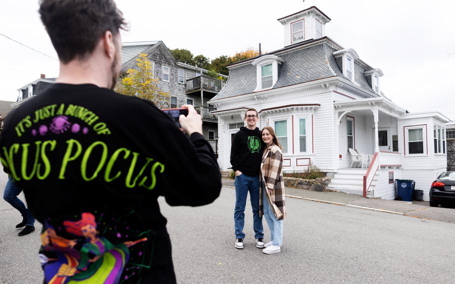 Visitors pose in front of the “Hocus Pocus” house, which looks just as it did when the Sanderson sisters paid their visit to Salem.