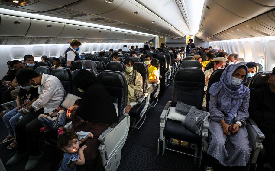 Evacuees from Afghanistan board a Boeing 777 before departing Naval Air Station Sigonella, Italy, Saturday, Aug. 28, 2021. Two evacuee flights left the air station over the weekend.