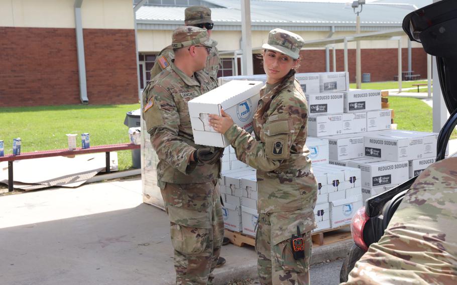 Soldiers prepare to pass out food and water in Perry, Fla., in the aftermath of Hurricane Helene.