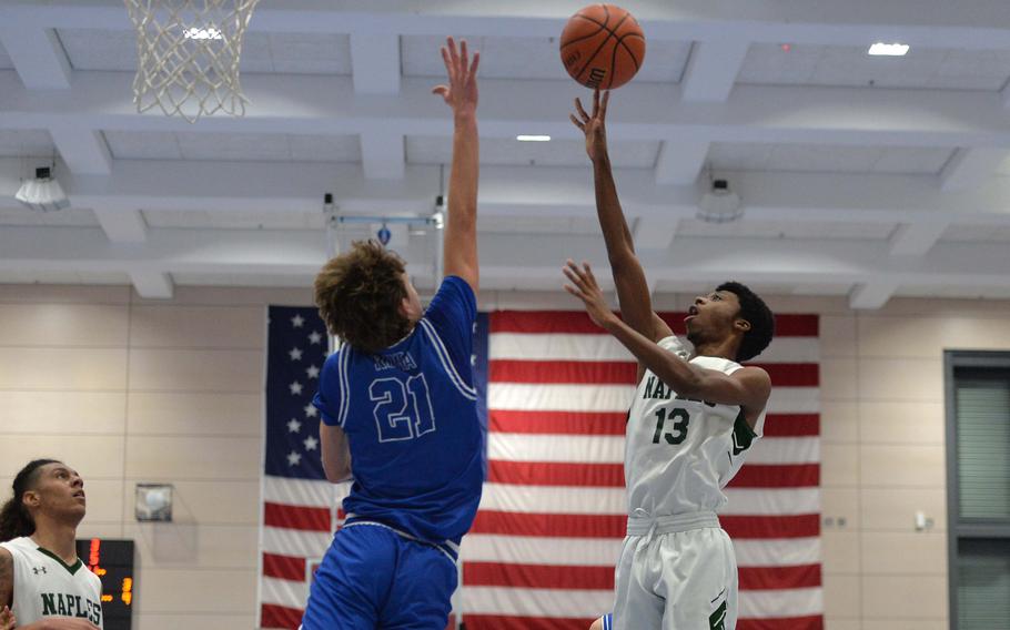 Naples’ Chris White shoots over Rota’s Tyler DeMeritt in the Division II championship game at the DODEA-Europe basketball finals in Ramstein, Germany, Feb. 18, 2023. Naples beat Rota 46-25 to take the division title.