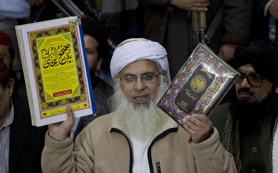 Maulana Abdul Aziz, the Red Mosque cleric and member of the Taliban negotiating team shows religious books in Islamabad, Pakistan, on Feb. 7, 2014. 
