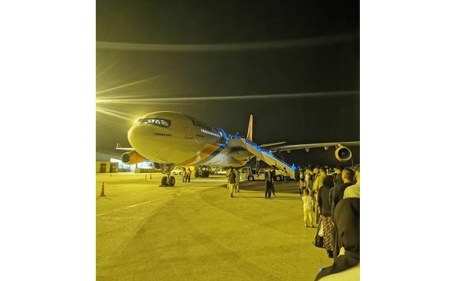 Some 383 Afghans wait to board an Airbus 340 on Sept. 24, 2021, as part of private rescue mission Operation Bella, named for the daughter of Jason Kander of Kansas City. 