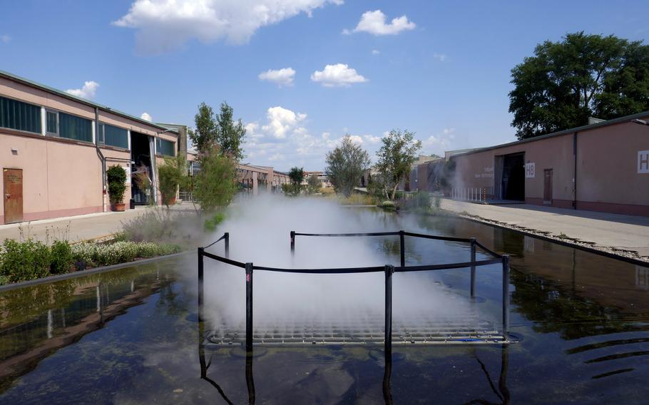 A fountain sprays a watery mist at the Bundesgartenschau, or BUGA, in Mannheim, Germany. The building surrounding it, known as the U-Halle, was a warehouse at what used to be the U.S. Army’s Spinelli Barracks. The German federal horticultural show being held there runs until Oct. 8, 2023.