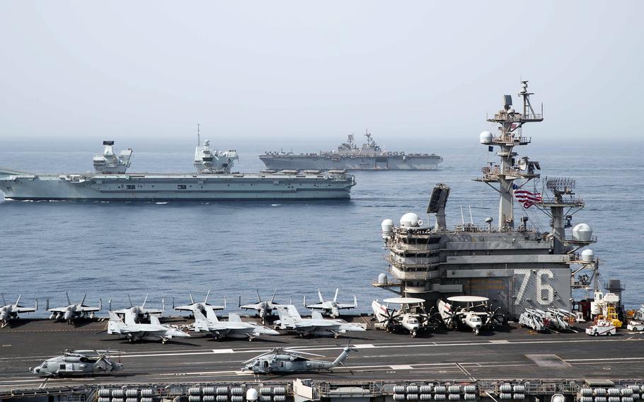 The aircraft carrier USS Ronald Reagan, foreground, the Royal Navy carrier HMS Queen Elizabeth, center, and the amphibious assault ship USS Iwo Jima steam through the Gulf of Aden, Monday, July 12, 2021. 