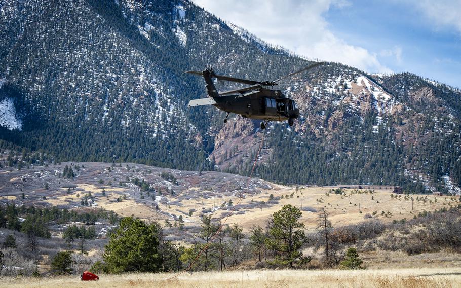 Firefighters from the U.S. Air Force Academy, Fort Carson and the Colorado Springs Fire Department dump water from air assets in their fight against the West Monument Creek Fire on the U.S. Air Force Academy on Monday, Feb. 26, 2024.