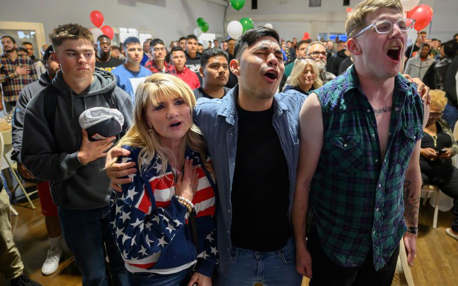 Liz Bauer, with the American Legion, and Camp Pendleton Marines, Mark Lopez, center, and Jack Maynes, sing to the National Anthem at the start of the Super Bowl game on
Sunday, Feb. 12, 2023. They were at a party for the Marines hosted by Crisp Imaging, Inc., and America Legion Harbor Post 291 in Newport Beach, Calif.