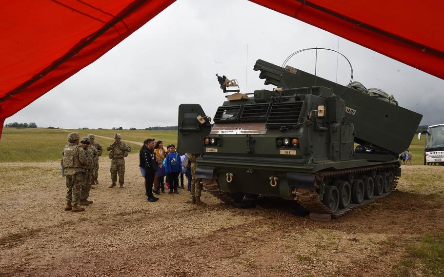 Family members with the 41st Field Artillery Brigade watch watch a scheduled live-fire exercise at the Grafenwoehr Training Area on Aug. 5, 2021. 