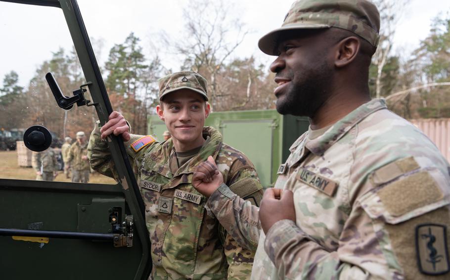 Pfc. Andrii Sydoruk, left, and Spc. Celestin Ntomb converse during a training exercise in Landstuhl, Germany, Feb. 9, 2024.