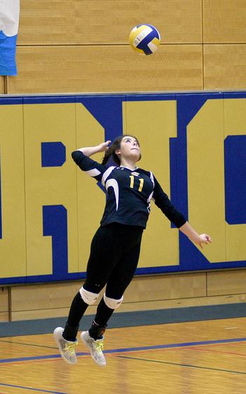Stuttgart outside hitter/defensive specialist Mia Snyder jumps up for a serve during a match against Ramstein on Sept. 9, 2023, at Wiesbaden High School in Wiesbaden, Germany.