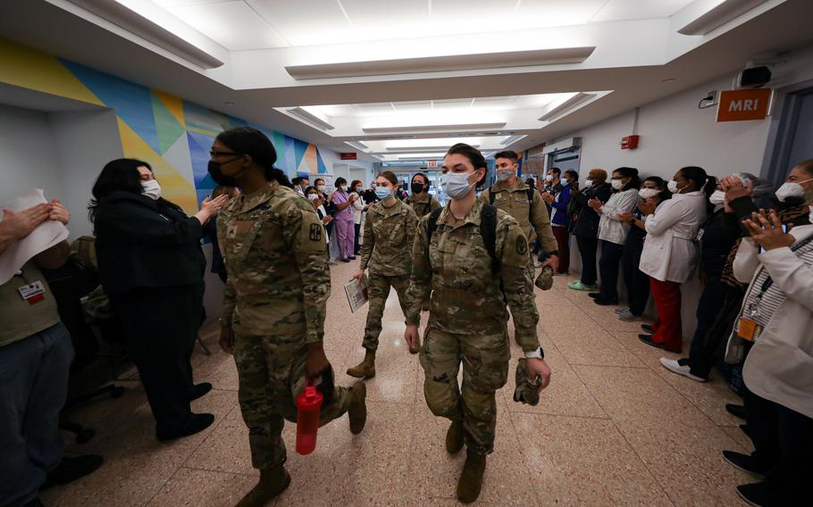 U.S. military medical team members assigned to 1st Medical Brigade from Fort Hood, Texas, are welcomed by staff as they arrive at the Coney Island Hospital in Brooklyn, N.Y., Jan. 22, 2022. 