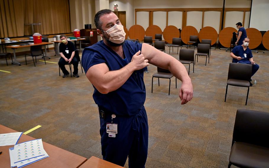 Brad Butcher, a Pittsburgh physician, prepares to get his second coronavirus vaccine in January. 