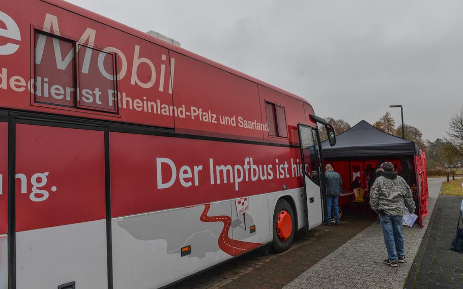 Patients wait outside a COVID-19 vaccination bus in Hoppstaedten-Weiersbach, Germany, on Nov. 16, 2021. Americans in Rheinland-Pfalz are eligible to receive vaccinations and booster shots from the bus, which travels throughout the state. 