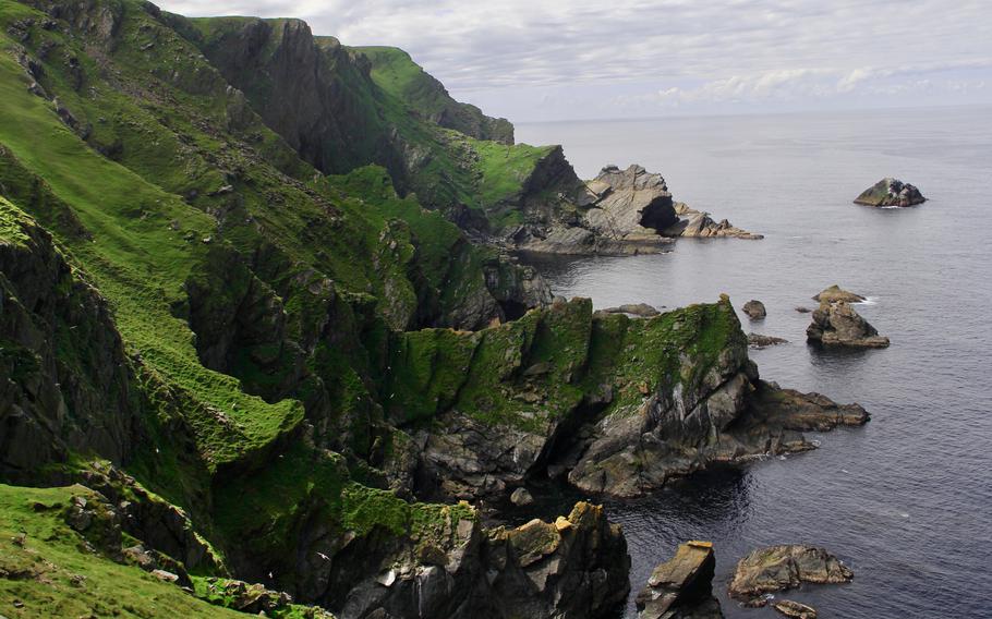 Vibrant grassy cliffs descend to the water in the Hermaness National Nature Reserve on Unst, which is closer to Norway than Edinburgh. 