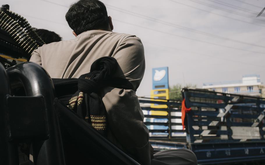 A man arrested at a Taliban checkpoint in Kabul on Sept. 30, 2021 is tied to a police vehicle while the unit commander decides his case.