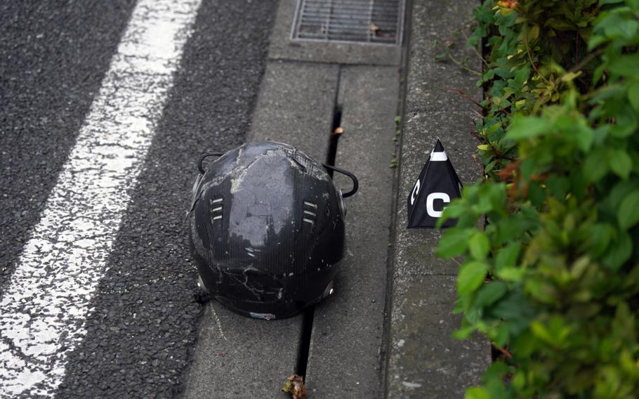 Japanese police investigate a deadly collision just outside the main gate for Yokosuka Naval Base, Japan, Wednesday, Sept. 6, 2023.