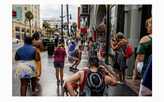 LOS ANGELES, CA - AUGUST 11, 2021: Despite the Delta variant, tourists are still flocking to Hollywood Boulevard to check out the Walk of Fame and other iconic sites on August 11, 2021 in Los Angeles, California.(Gina Ferazzi / Los Angeles Times)