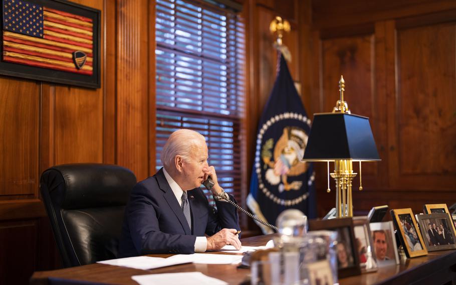 In this image provided by The White House, President Joe Biden speaks with Russian President Vladimir Putin on the phone from his private residence in Wilmington, Del., Thursday, Dec. 30, 2021. 