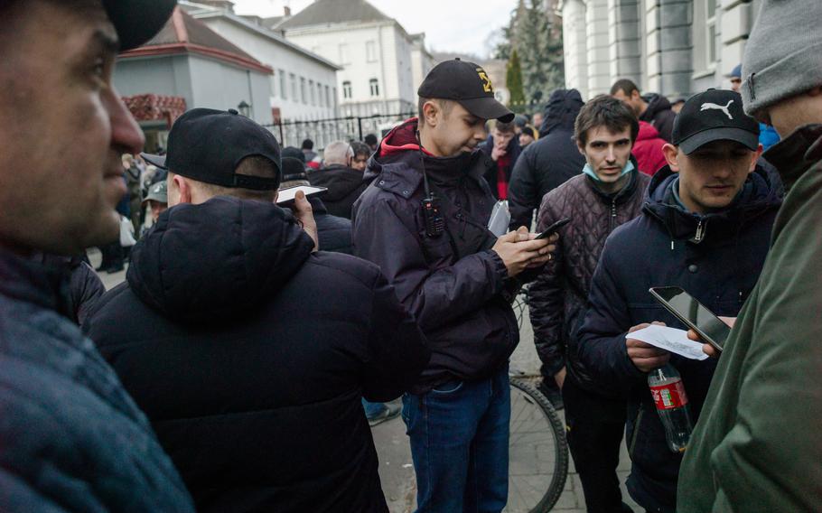 People gather outside a military compound in Lviv to be enlisted in the Territorial Defense Force on Feb. 26, 2022.