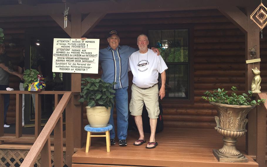 A photo of retired U.S. Air Force Lt. Col. Bill Burhans, right, and retired U.S. Army Col. Tom Spencer, next to a USMLM sign outside Burhans’ Texas home in 2018. The men have remained close since they reported being drugged by the Soviets in 1979 and 1981 respectively.