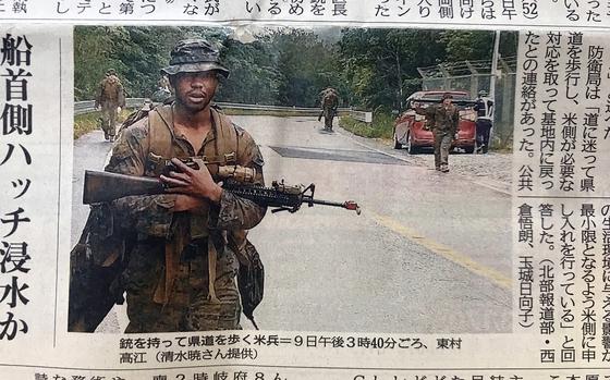 A photo of several U.S. Marines walking on a roadway in Higashi village appeared in the Okinawa Times newspaper, Saturday, Dec. 10, 2022.