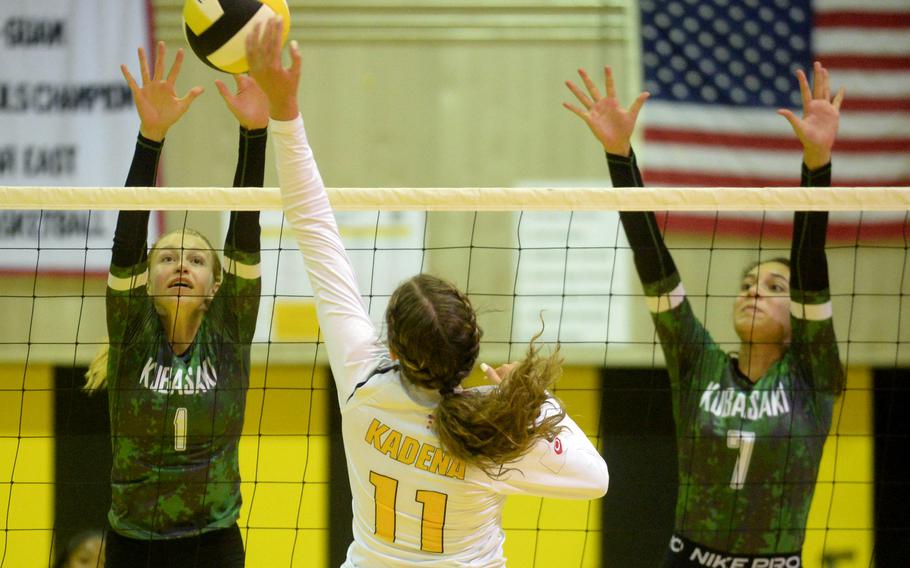 Kadena’s Presley Pearce spikes against Kubasaki’s Emma Leggio and Sophia Grubbs during Tuesday’s Okinawa girls volleyball regular-season finale. 