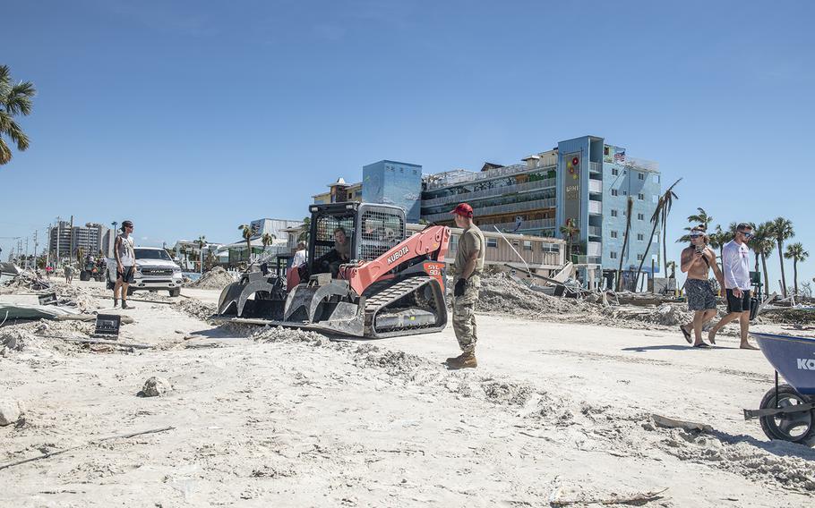Members of the 202nd Red Horse Squadron clear roads in Fort Myers Beach, Florida, in response to Hurricane Ian on Friday, Sept. 30, 2022.