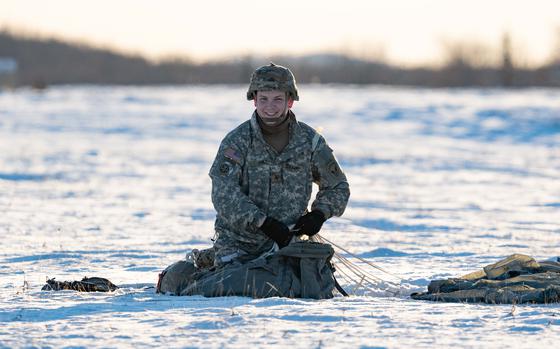 Army Sgt. Jake Ames, a paratrooper assigned to the 725th Brigade Support Battalion, 11th Airborne Division, packs up his gear after a jump at Malemute Drop Zone, Alaska, Nov. 4, 2022. Paratroopers from the 11th Airborne are among those flying to Finland and other northern European nations for Arctic Forge, an inaugural multinational exercise. 