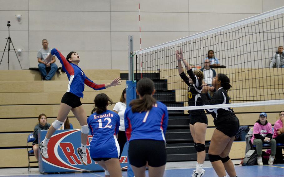 Ramstein’s Sophia Schluth prepares to spike the ball as teammates Jodia Relojo and Keilani Gonzalez watch during the Royals’ match against Stuttgart on Saturday at Ramstein Air Base, Germany. The Panthers’ Icsiss Perez, right, and a teammate prepare to block at the net. 