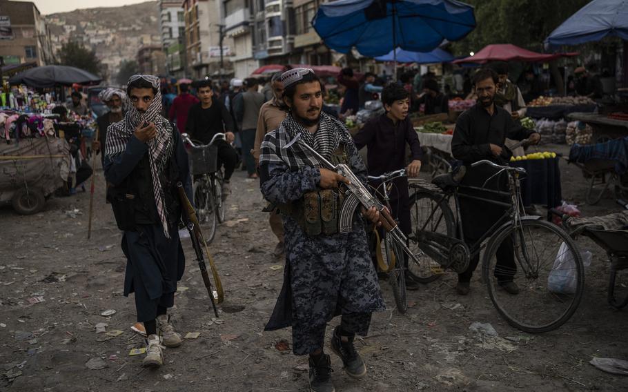 Taliban fighters patrol a market in Kabul's Old City, Afghanistan, Tuesday, Sept. 14, 2021.