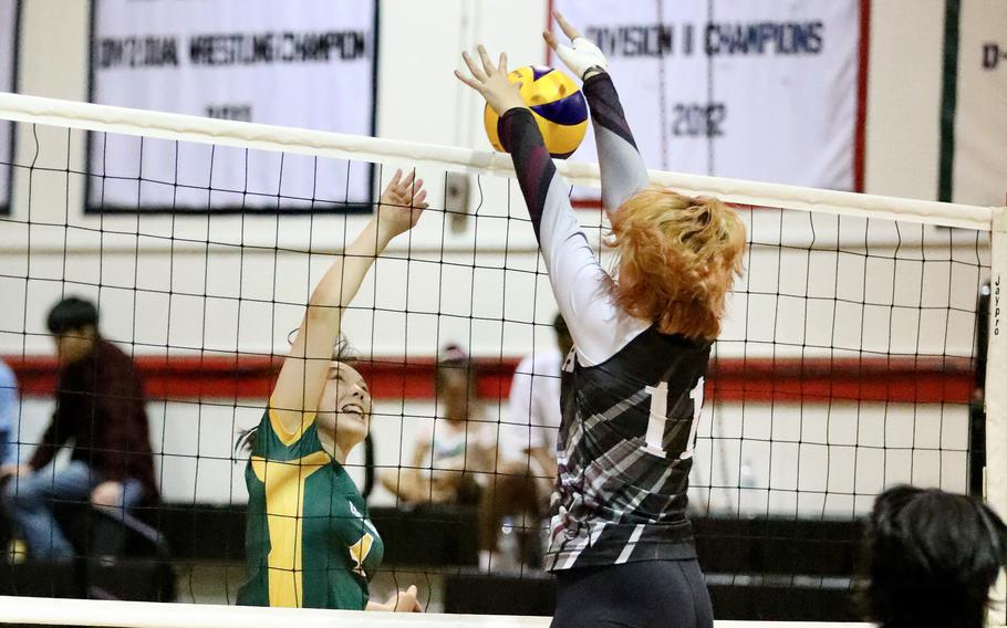 Robert D. Edgren's Milan Bean spikes into the block of Zama's Kaitlynn McAbee. The Trojans won both weekend matches, Friday's in four sets and Saturday's in three.