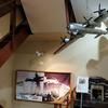A model of a U.S. B-29 Superfortress bomber hangs over a  model of a Japanese civilian bomb shelter at the Center of the Tokyo Raids and War Damage in Tokyo, April 22, 2025.