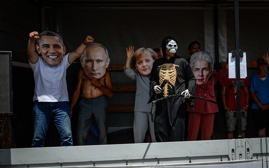 Activists wearing giant masks representing prominent politicians took to the state during a peace protest led by the symbolic character “Death” in Ramstein-Miesenbach, Germany, June 25, 2022. 