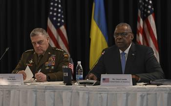 U.S. Army Gen. Mark Milley, left, and Defense Secretary Lloyd Austin listen to opening remarks at the Ukraine Defense Contact Group meeting Sept. 19, 2023, at Ramstein Air Base in Germany.