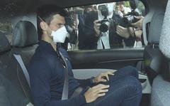 Serbian tennis player Novak Djokovic rides in car as he leaves a government detention facility before attending a court hearing at his lawyers office in Melbourne, Australia, Sunday, Jan. 16, 2022.