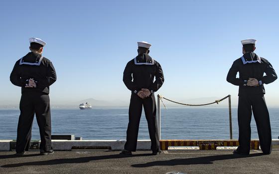 Sailors man the rails of the aircraft carrier USS Nimitz in San Diego in February 2021.