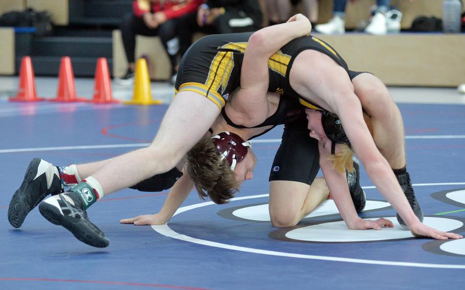 Vilseck’s Lukas Ahrend beat Stuttgart’s Aidan Morgan, top, in a 120-pound match at the high school 2022 Wrestling Tournament in Ramstein, Germany, Feb. 11, 2022.