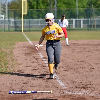 Kyra Cole gets set to pick up a bat after scoring.