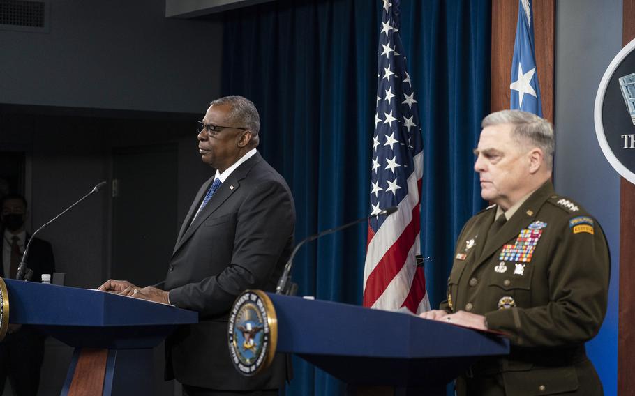 Defense Secretary Lloyd Austin and Gen. Mark Milley, chairman of the Joint Chiefs of Staff, speak Friday, Jan. 28, 2022, during a news briefing at the Pentagon.