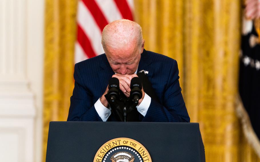 President Biden bows his head as a question is asked in the East Room at the White House on Aug. 26, 2021. 