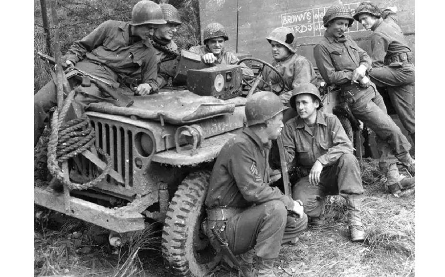 Soldiers listen to AFN on the radio during World War II. AFN is celebrating its 80th anniversary this month. Going by the writing on the wall behind them, they might have been listening to a broadcast of the 1944 World Series between the St. Louis Browns and their crosstown rivals, the Cardinals.