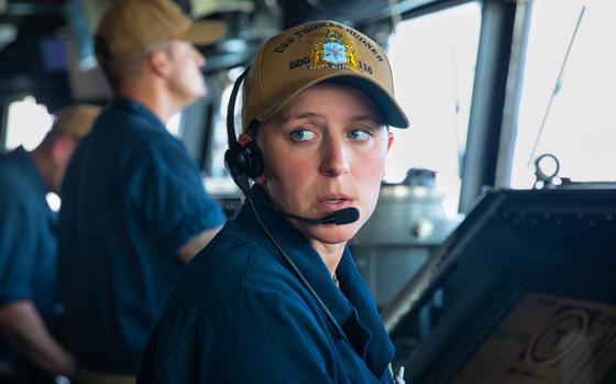 A sailor assigned to the Arleigh Burke-class guided missile destroyer USS Thomas Hudner, passes information through a headset, Oct. 10, 2022. U.S. Central Command said the USS Thomas Hudner shot down bomb-carrying drones launched from territory controlled by Yemen’s Houthi rebels.