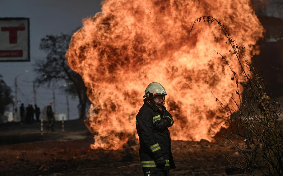 A Ukrainian firefighter stands next to flames rising from a fire following artillery fire on the 30th day on the invasion of the Ukraine by Russian forces in the northeastern city of Kharkiv on March 25, 2022. Russian strikes targeting a medical facility in Kharkiv on March 25, 2022, killed at least four civilians and wounded several others, Ukrainian officials said. 