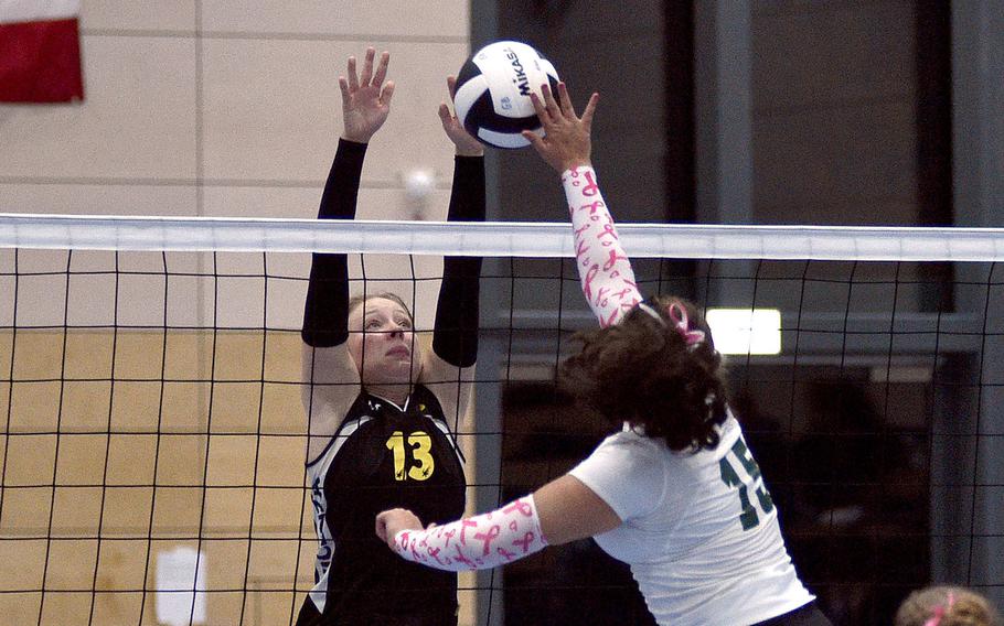 Vicenza's Avonlea Sparling goes up to block an attack by Naples' Mackinzi Dudley during pool-play action of the DODEA European volleyball championships on Oct. 26, 2023, at Ramstein High School on Ramstein Air Base, Germany.