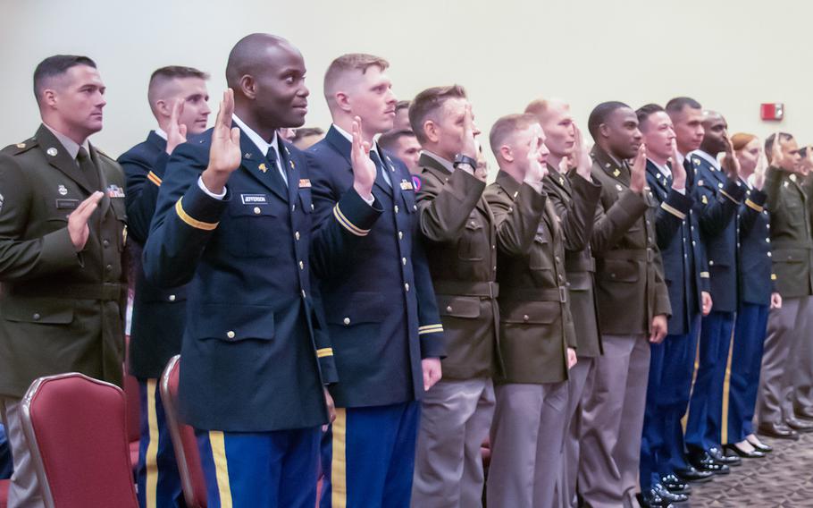 Graduates of the 129th Regiment Officer Candidate School, Camp Lincoln, Ill., recite the oath of office as newly commissioned second lieutenants at a ceremony in August 2022.