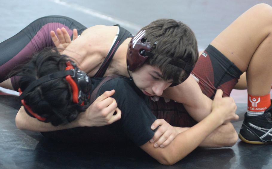 Matthew C. Perry's Trevor Hughes tries to finish off E.J. King's Alyssa Garcia during Saturday's DODEA-Japan wrestling dual meet. Hughes won by technical fall 10-0 in 2 minutes, 16 seconds, and the Samurai won the meet 27-25.