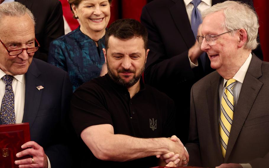Ukrainian President Volodymyr Zelenskyy presents an award