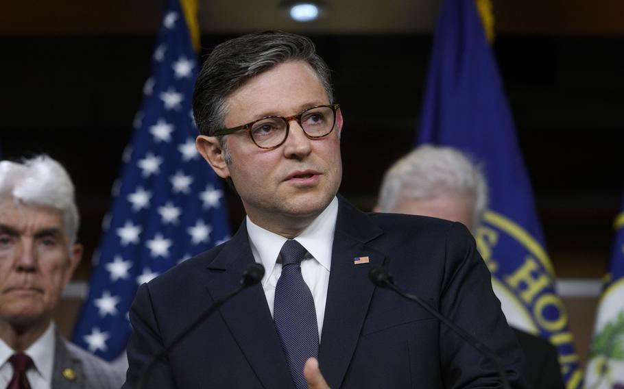 Johnson wears an American flag pin on his lapel during a news conference.