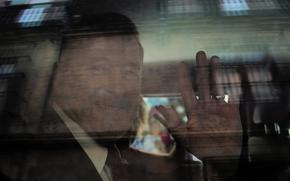 U.S. Ambassador to Mexico Ronald Johnson waves from the inside of a vehicle while leaving the National Palace.